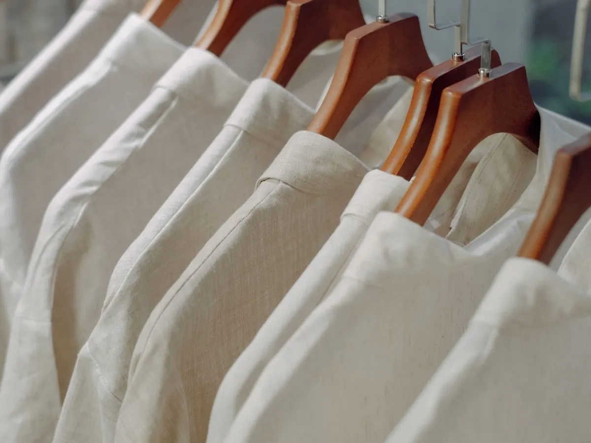 Freshly pressed dress shirts on wooden hangers, cleaned and ready for pickup