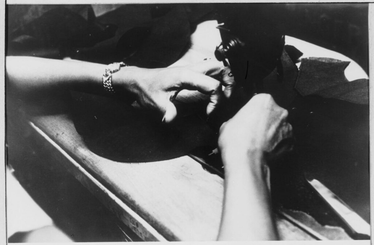 Expert hands carefully working on garment detail