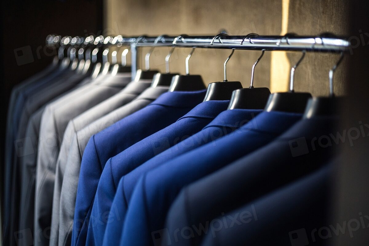 Freshly pressed suits hanging on a rack at Dry Cleaning Butler